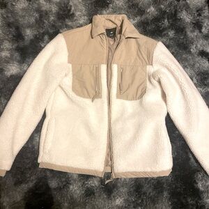 white and cream colored seasonal jacket.